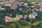 Aerial photo of baroque castle Karlova Koruna surrounded by parks and trees and city in the background