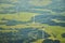 Aerial photo of beautiful landscape with meadows, forests and fields with wind turbines