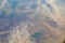 Aerial photo of Farmland. view from the plane to the ground. squares of fields under the clouds