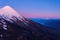 Aerial photo from high altitude of the snowy summit of the volcano osorno in the blue hour