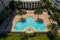 Aerial photo luxury swimming pool with palm trees