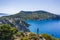 Aerial photo of man traveler on the cliff edge of beautiful and picturesque rocky coast close to Assos village on