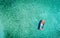 Aerial photo of motorboat tied up in turquoise sea water, Greece