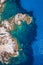 Aerial photo over granite rocky coastline Mediterranean crystal clear blue sea water. Aerial photo of ocean waves hitting rocky