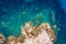 Aerial photo over granite rocky coastline Mediterranean crystal clear blue sea water. Aerial photo of ocean waves hitting rocky