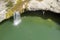 An aerial photo of a person jumping into a lake, Zarecki krov, Pazin, Istria, Croatia