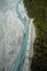 An aerial photo of a river and forests  at the foot of the Franz Josef glacier at the southern island of New Zealand.