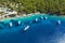 Aerial photo of sailing boats docked in blue bay of Fiskardo, Kefalonia island, Ionian, Greece