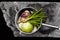 Aerial photo of a saucepan with vegetables on a stone slab.