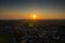 Aerial photo showing the sunrising or sun setting over the town of Leeds West Yorkshire in the UK, showing a typical British