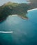 An aerial photo of a small speedboat and one of the islands in Whitsundays in Australia