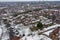 Aerial photo of a snowy day in the city of Leeds in the UK, showing rows of terrace houses with snow covered roofs in the Village