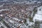 Aerial photo of a snowy day in the city of Leeds in the UK, showing rows of terrace houses with snow covered roofs in the Village