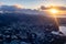 Aerial Photo Of The Sun Rising Over The Mountains And The City Of Honolulu, Oahu, Hawaii, USA