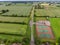 Aerial photo of the UK British town of Wheldrake that is in the City of York in West Yorkshire, showing the green grassy fields