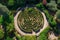 This aerial photograph captures the stunning expanse of a meticulously designed large circular garden, A top view of a