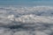 Aerial photograph of clouds outside of an airplane window while flying