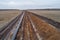 Aerial photograph of the laying pipe of large diameter in clay soil. Autumn