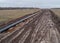 Aerial photograph of the laying pipe of large diameter in clay soil. Autumn