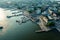 An aerial photograph showcasing a bustling harbor in a city, with various vessels and structures engaged in maritime activities,