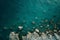 An aerial photograph showing a body of water enclosed by rocks, A high-altitude image of a tranquil sea and scattered rocks, AI