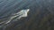 Aerial photographs of a high-speed white pleasure boat sailing in the waters of the Gulf of Finland.Big waves from the