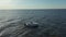 Aerial photographs of a high-speed white pleasure boat sailing in the waters of the Gulf of Finland.Big waves from the