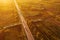 Aerial photography of cars driving on road through plain countryside landscape scenery in sunset