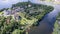 Aerial photography of a plot of land surrounded by water and greenery a Sunny summer day