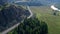 Aerial photography Road between trees along the river driving cars on the road