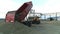 Aerial photography unloading grain from trucks at the grain warehouse in September in the evening