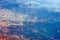 Aerial photography. View from the plane window: mountains and green fields. Travel and tourism concept.