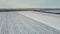 Aerial photography of wheat field covered by snow and wheat or barley crops in winter farmland