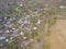 Aerial photos of small towns In Thailand, surrounded by arid fields, there is a road through