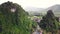 Aerial of picturesque countryside village with cliffs covered of lush greenery.