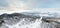 Aerial Picturesque panoramic landscape in the Altai mountains with snow-capped peaks under a blue sky with clouds in winter with