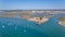 Aerial. The pier in the bay, the four waters of Tavira Island.