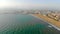 Aerial Port of Valencia from the altitude. Flight over the sea in the direction of the port. Panorama of the port in