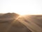 Aerial postcard panorama sunset view of isolated lonely single man person dry sand dunes desert of Huacachina Ica Peru