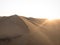 Aerial postcard panorama sunset view of isolated lonely single man person dry sand dunes desert of Huacachina Ica Peru