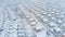 AERIAL: Pristine white snow covers the empty streets of a suburban neighborhood.