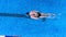 AERIAL: professional swimmer in a swimming pool.