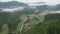 Aerial pullback as morning fog clears over remote mountain village