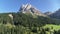 Aerial pullback from massive mountain in the Alps. Flying away from Peitlerkofel