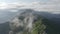 Aerial raising up to top shot. Mountain ridge panorama clouds flight
