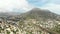 Aerial real time panoramic high wide angle view Calpe hillside houses townscape panorama, rocky mountains cloudy sky. Province of
