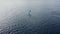 Aerial rear view to colorful crab claw sail on white wooden Jukung outrigger boat near shore of Bali