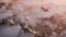 Aerial of red airplane flying over grey rock mountain landscape