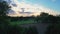 Aerial reveal footage: dramatic sunset over a plowed farm field