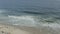 Aerial, reversed shot of a sandy Ipanema beach and ocean in Rio de Janeiro